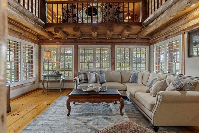 562 Rocky Ridge Rd E, Rock Island, TN 38581 - living room with log walls, a high ceiling, and wood-type flooring