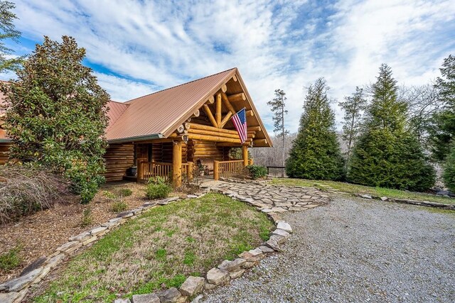 562 Rocky Ridge Rd E, Rock Island, TN 38581 - view of front of house with log exterior, a porch, and metal roof