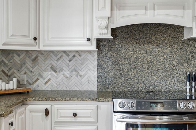 562 Rocky Ridge Rd E, Rock Island, TN 38581 - kitchen with range, backsplash, dark countertops, and white cabinets