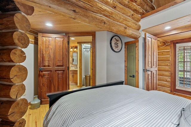 562 Rocky Ridge Rd E, Rock Island, TN 38581 - bedroom featuring log walls, light wood-style floors, wood ceiling, and recessed lighting