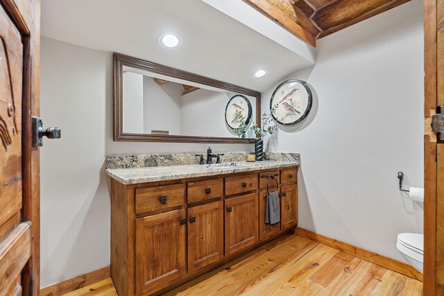 562 Rocky Ridge Rd E, Rock Island, TN 38581 - half bath with toilet, vanity, baseboards, wood finished floors, and recessed lighting
