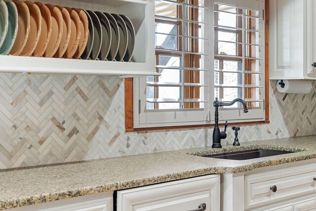 562 Rocky Ridge Rd E, Rock Island, TN 38581 - kitchen with a sink, decorative backsplash, white cabinetry, and light stone counters