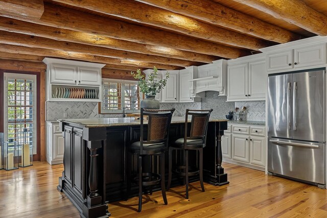 562 Rocky Ridge Rd E, Rock Island, TN 38581 - kitchen with freestanding refrigerator, white cabinets, plenty of natural light, and beam ceiling