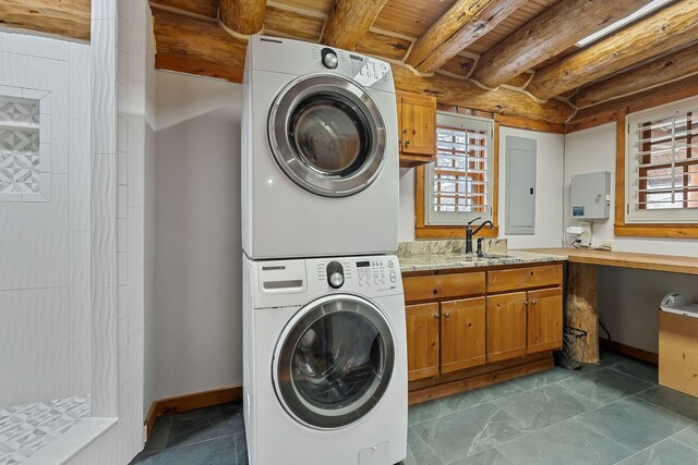562 Rocky Ridge Rd E, Rock Island, TN 38581 - laundry room with estacked washer and dryer, electric panel, plenty of natural light, wooden ceiling, and baseboards