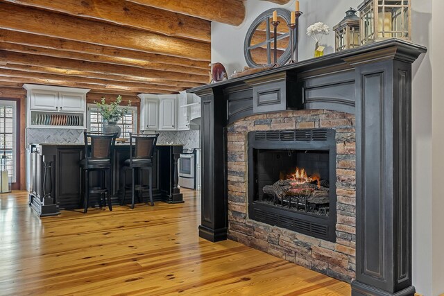 562 Rocky Ridge Rd E, Rock Island, TN 38581 - living area with light wood-style flooring, a fireplace, and beam ceiling