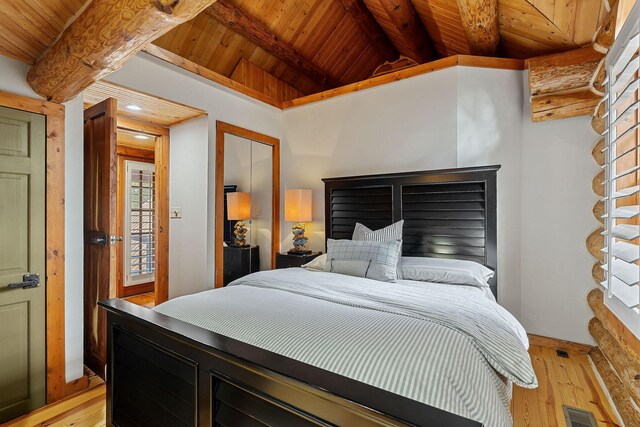 562 Rocky Ridge Rd E, Rock Island, TN 38581 - bedroom featuring wood ceiling with exposed beams, light wood-style floors, and baseboards
