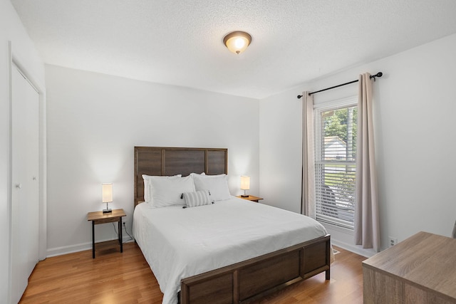 684 Dutchmans Dr, Hermitage, TN 37076 - bedroom with wood finished floors, a textured ceiling, and baseboards