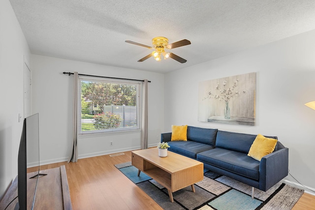 684 Dutchmans Dr, Hermitage, TN 37076 - living room featuring ceiling fan, wood finished floors, baseboards, and a textured ceiling