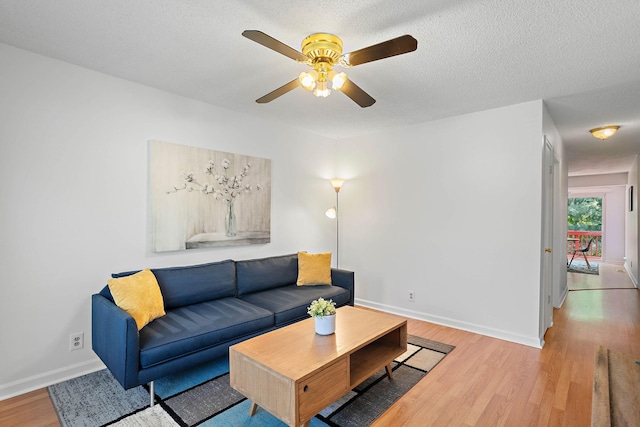 684 Dutchmans Dr, Hermitage, TN 37076 - living room featuring light wood finished floors, a ceiling fan, baseboards, and a textured ceiling