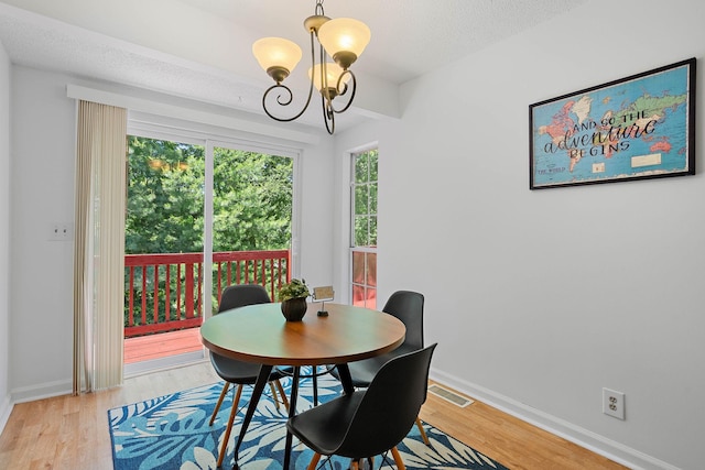 684 Dutchmans Dr, Hermitage, TN 37076 - dining area featuring a chandelier, light wood-type flooring, baseboards, and a textured ceiling