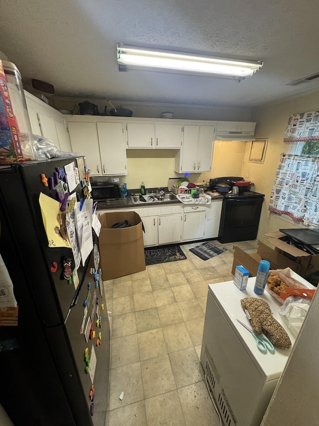 305 E Park Ave Unit 305And 307, Gallatin, TN 37066 - kitchen featuring black appliances, white cabinetry, and a textured ceiling