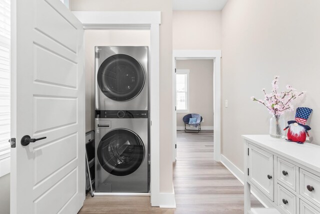 207 Charleston Ave, Pleasant View, TN 37146 - laundry room with stacked washer and clothes dryer, light wood-style flooring, and baseboards