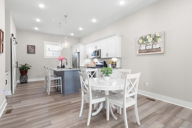 207 Charleston Ave, Pleasant View, TN 37146 - dining space featuring light wood finished floors, recessed lighting, and baseboards