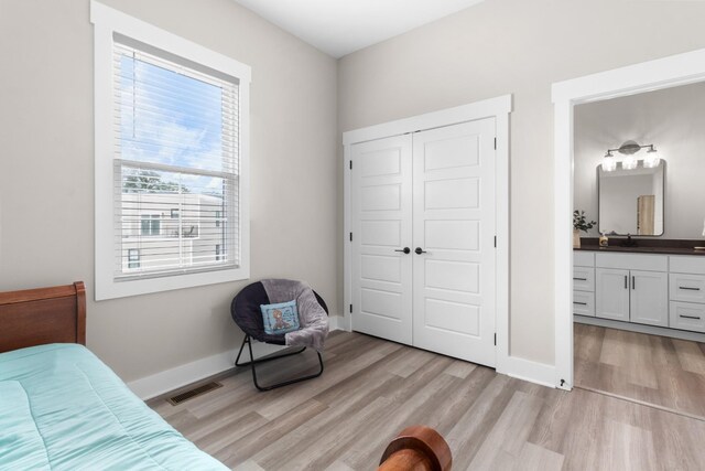 207 Charleston Ave, Pleasant View, TN 37146 - bedroom featuring light wood-style flooring, a sink, a closet, and baseboards