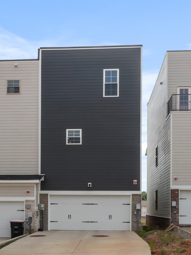 207 Charleston Ave, Pleasant View, TN 37146 - view of side of property featuring an attached garage, brick siding, and driveway