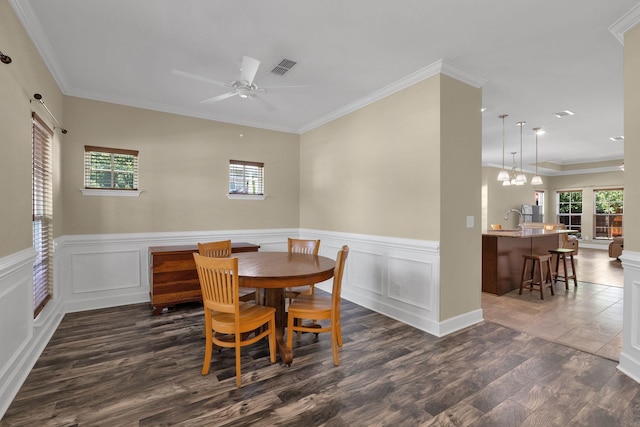 1596 Winding Creek Dr, Nolensville, TN 37135 - dining room with plenty of natural light, ceiling fan, dark wood-style flooring, wainscoting, and ornamental molding