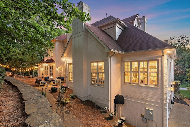 30 Park Mdws, Nashville, TN 37215 - view of home's exterior featuring a chimney, a shingled roof, and a patio area