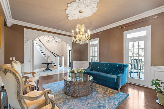 30 Park Mdws, Nashville, TN 37215 - living area with stairway, a chandelier, a wainscoted wall, arched walkways, and wood finished floors
