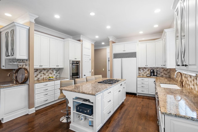 30 Park Mdws, Nashville, TN 37215 - kitchen featuring paneled fridge, ornamental molding, a center island, tasteful backsplash, and white cabinets