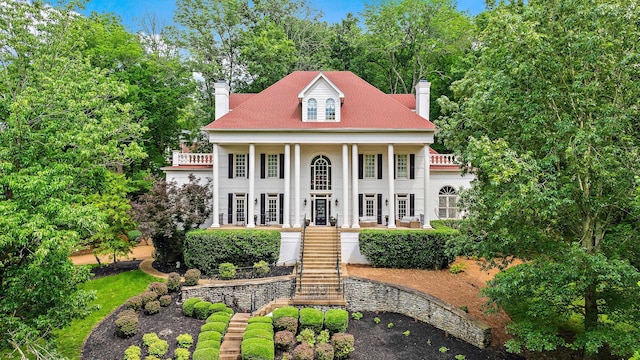 30 Park Mdws, Nashville, TN 37215 - greek revival inspired property with a chimney, covered porch, stairway, and stucco siding