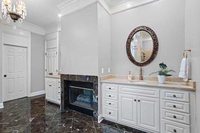 30 Park Mdws, Nashville, TN 37215 - bathroom with marble tiled floors, crown molding, two vanities, a chandelier, and a premium fireplace