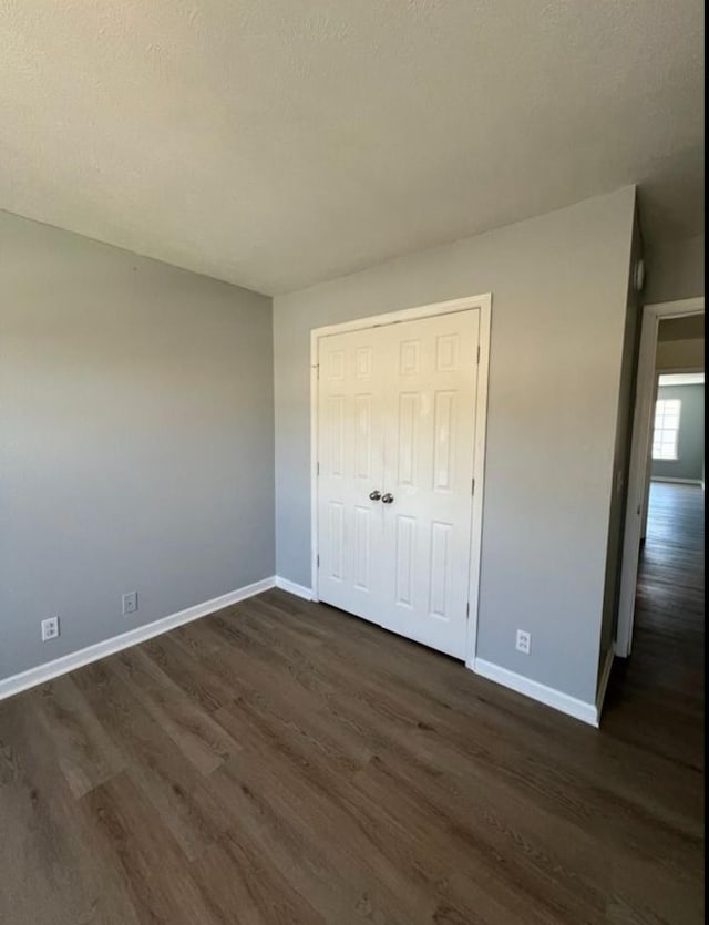 3715 Red Willow Ct, Murfreesboro, TN 37128 - unfurnished bedroom with dark wood-style flooring, baseboards, and a closet