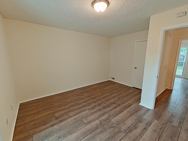 7 E Ln, Fayetteville, TN 37334 - empty room with dark wood finished floors, a textured ceiling, and baseboards