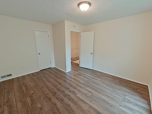 7 E Ln, Fayetteville, TN 37334 - spare room featuring wood finished floors, a textured ceiling, and baseboards