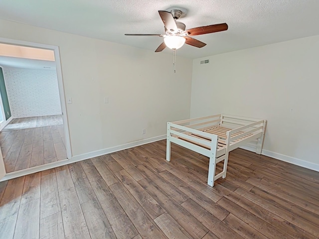 7 E Ln, Fayetteville, TN 37334 - unfurnished bedroom with hardwood / wood-style flooring, a textured ceiling, baseboards, and ceiling fan