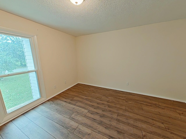 7 E Ln, Fayetteville, TN 37334 - empty room with hardwood / wood-style flooring, a textured ceiling, and baseboards