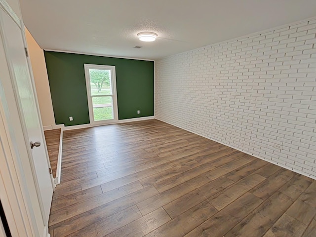 7 E Ln, Fayetteville, TN 37334 - empty room with brick wall, dark wood-type flooring, and baseboards
