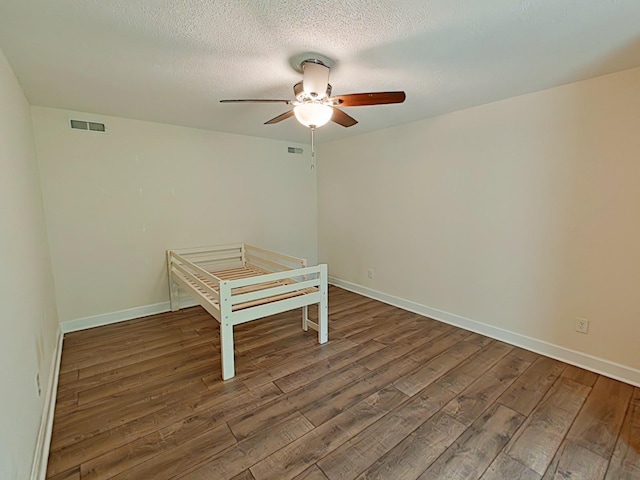 7 E Ln, Fayetteville, TN 37334 - unfurnished bedroom with wood finished floors, baseboards, ceiling fan, and a textured ceiling