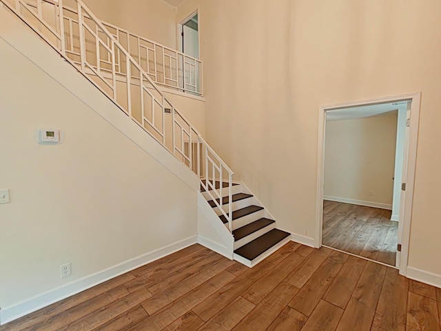 7 E Ln, Fayetteville, TN 37334 - stairs featuring hardwood / wood-style flooring, baseboards, and a towering ceiling