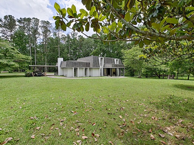 7 E Ln, Fayetteville, TN 37334 - view of front of house featuring a front yard, a chimney, a shingled roof, and view of wooded area