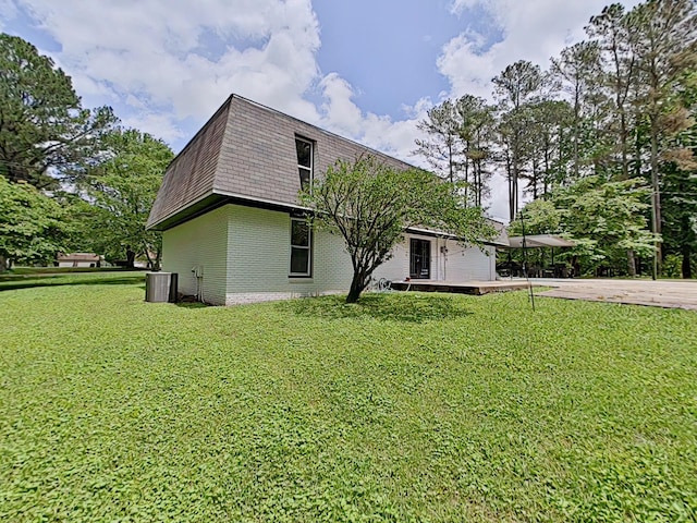 7 E Ln, Fayetteville, TN 37334 - rear view of property with mansard roof, central AC, a lawn, brick siding, and driveway