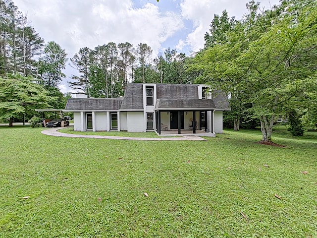 7 E Ln, Fayetteville, TN 37334 - rear view of house with roof with shingles, a yard, mansard roof, and view of wooded area