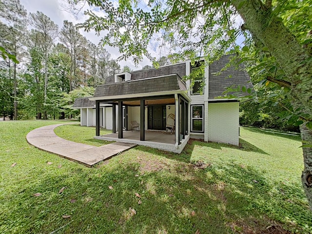 7 E Ln, Fayetteville, TN 37334 - back of house featuring a shingled roof, a patio area, mansard roof, and a lawn