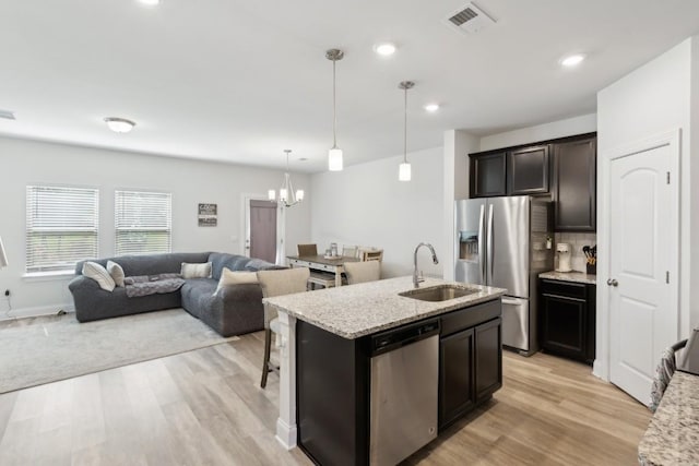 1342 Vilda Way Unit 300, Lebanon, TN 37087 - kitchen featuring stainless steel appliances, a sink, light wood-type flooring, a chandelier, and open floor plan