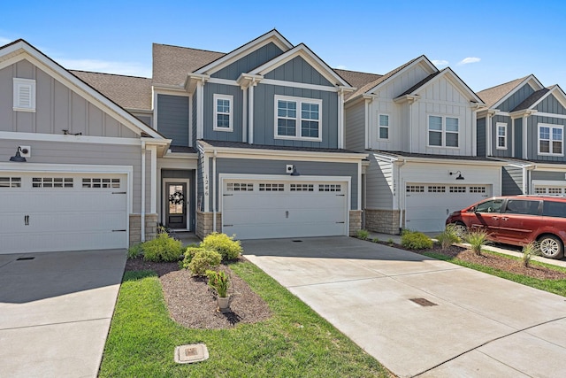 1246 June Wilde Rdg, Spring Hill, TN 37174 - view of front of house with board and batten siding, driveway, stone siding, and a garage