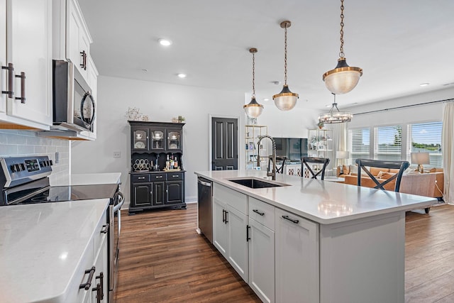 1246 June Wilde Rdg, Spring Hill, TN 37174 - kitchen featuring appliances with stainless steel finishes, a sink, decorative backsplash, white cabinets, and light countertops
