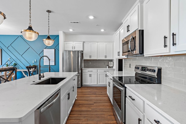 1246 June Wilde Rdg, Spring Hill, TN 37174 - kitchen with appliances with stainless steel finishes, a sink, white cabinetry, dark wood-type flooring, and recessed lighting