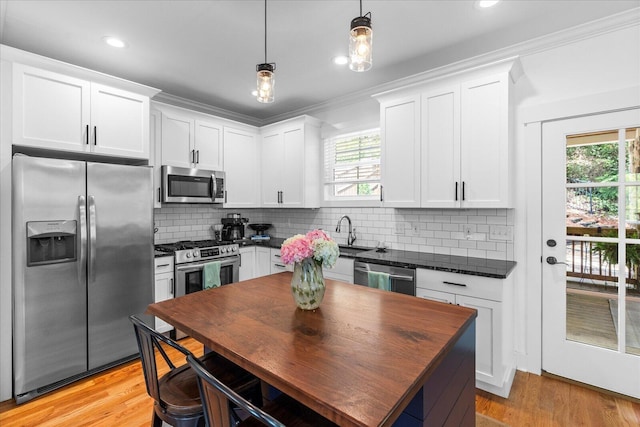 500 Beck Ave, Chattanooga, TN 37405 - kitchen with stainless steel appliances, dark countertops, white cabinetry, light wood-type flooring, and recessed lighting