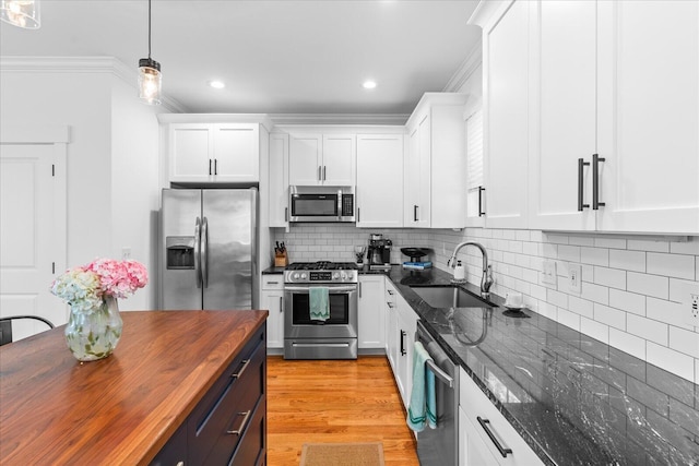 500 Beck Ave, Chattanooga, TN 37405 - kitchen with stainless steel appliances, wooden counters, crown molding, white cabinets, and backsplash