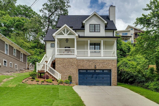 500 Beck Ave, Chattanooga, TN 37405 - view of front of house featuring a front lawn, brick siding, concrete driveway, stairs, and a garage