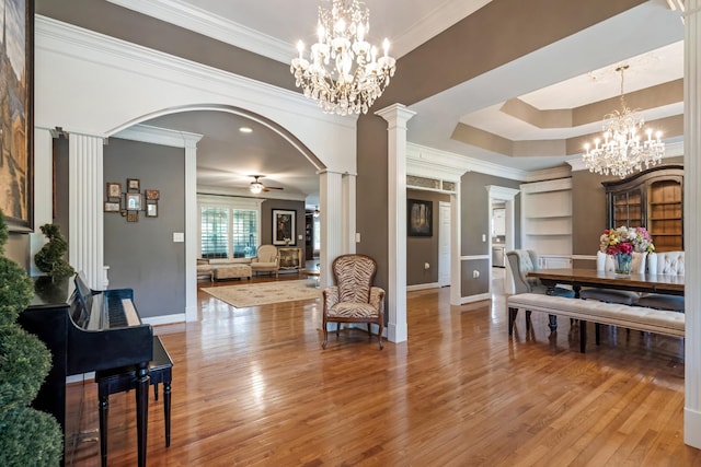 1205 Sequoya Trl, Columbia, TN 38401 - dining area with ornate columns, ornamental molding, wood finished floors, arched walkways, and a chandelier
