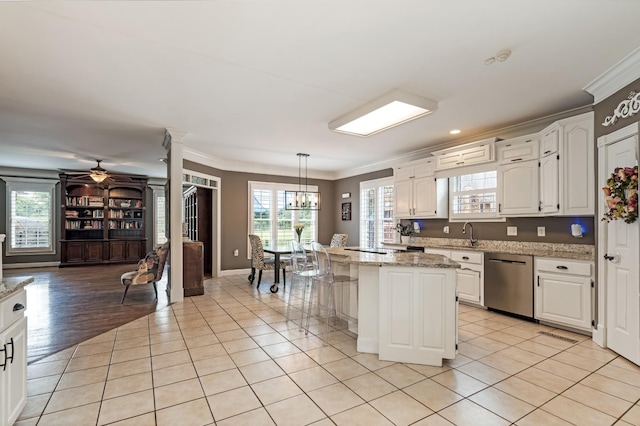 1205 Sequoya Trl, Columbia, TN 38401 - kitchen with stainless steel dishwasher, crown molding, white cabinetry, and light tile patterned floors