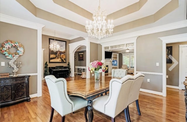 1205 Sequoya Trl, Columbia, TN 38401 - dining space with a chandelier, arched walkways, wood finished floors, ornamental molding, and a raised ceiling