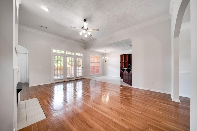 122 Belmont Cir, Hendersonville, TN 37075 - unfurnished living room with ceiling fan, light wood-type flooring, a chandelier, ornamental molding, and arched walkways