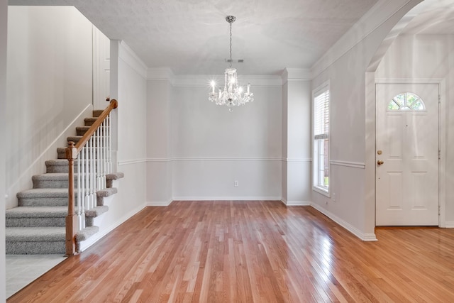 122 Belmont Cir, Hendersonville, TN 37075 - foyer featuring light wood-style flooring, a chandelier, stairway, baseboards, and arched walkways