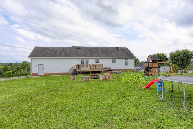 3970 Pleasant Grove Rd, White House, TN 37188 - rear view of house featuring a trampoline, a playground, a wooden deck, and a lawn